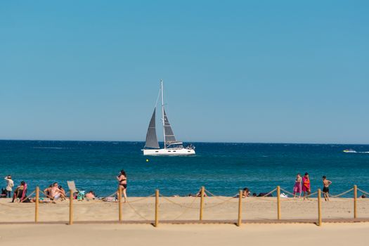 Canet en Roussillon, France: June 21, 2020: People in the beach. Sunny day in the tourist town of Canet en Roussillion in France on the Mediterranean Sea.