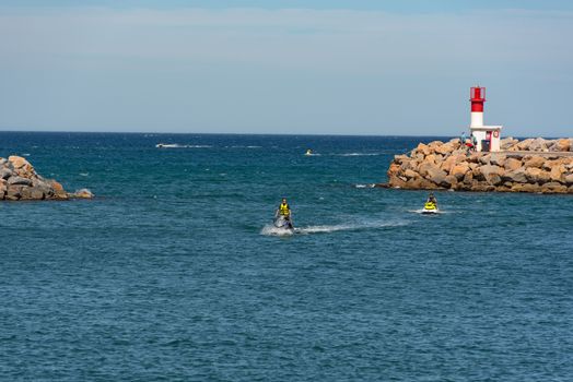 Canet en Roussillon, France: June 21, 2020:  People ride in jetski Sunny day in the tourist town of Canet en Roussillion in France on the Mediterranean Sea.