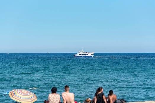 BARCELONA - JUNE 26, 2020: Barceloneta beach with people in summer after COVID 19 on June 26, 2020 in Barcelona, ​​Spain.