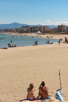 Canet en Roussillon, France: June 21, 2020: People in the beach. Sunny day in the tourist town of Canet en Roussillion in France on the Mediterranean Sea.