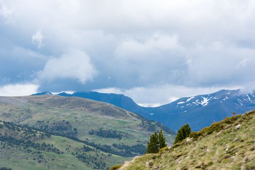 Sunny day with low clouds in the town of Pas de la Casa on the border between France and Andorra in June 2020.