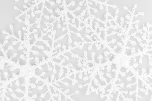 White Snowflakes on isolated on white background. Christmas composition. Frame made of white snowflakes on white background.