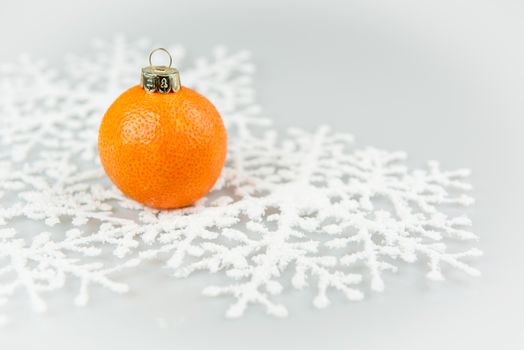 Tangerine as a xmas ball on Christmas and New Year isolated on a white background.