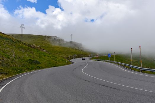 Sunny day with low clouds in the town of Pas de la Casa on the border between France and Andorra in June 2020.