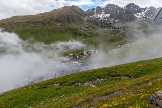 Pas de la Casa, Encamp. Andorra : 2020 17 June : Sunny day with low clouds in the town of Pasa de la casa on the border between Fracia and Andorra in June 2020.