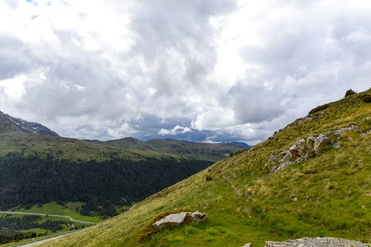 Sunny day with low clouds in the town of Pas de la Casa on the border between France and Andorra in June 2020.