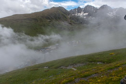 Pas de la Casa, Encamp. Andorra : 2020 17 June : Sunny day with low clouds in the town of Pasa de la casa on the border between Fracia and Andorra in June 2020.