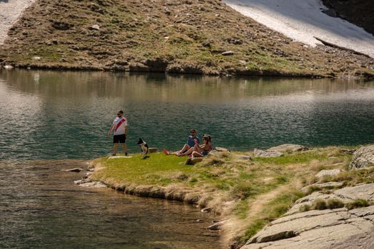 Canillo, Andorra : 2020 26 may : Young people Beautiful Querol Lake in the mountain refuge in the Incles Valley, Canillo, Andorra