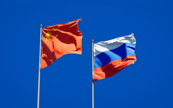 Beautiful national state flags of Russia and China together at the sky background. 3D artwork concept. 
