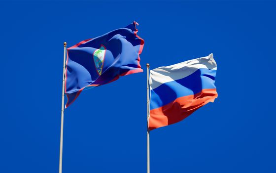 Beautiful national state flags of Russia and Guam together at the sky background. 3D artwork concept. 