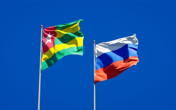 Beautiful national state flags of Togo and Russia together at the sky background. 3D artwork concept. 
