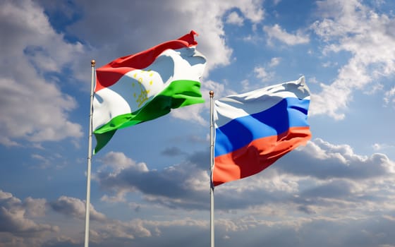 Beautiful national state flags of Tajikistan and Russia together at the sky background. 3D artwork concept. 