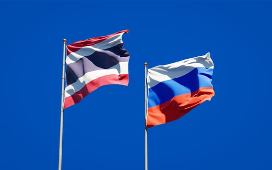 Beautiful national state flags of Thailand and Russia together at the sky background. 3D artwork concept. 