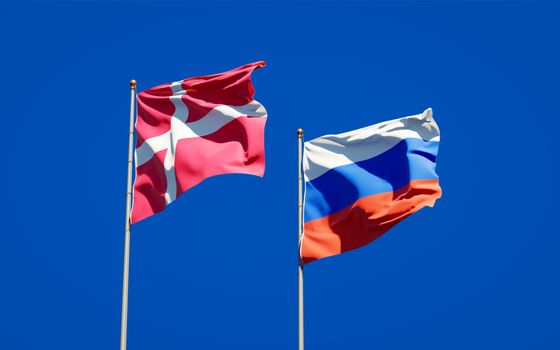 Beautiful national state flags of Denmark and Russia together at the sky background. 3D artwork concept. 