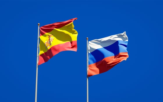 Beautiful national state flags of Spain and Russia together at the sky background. 3D artwork concept. 