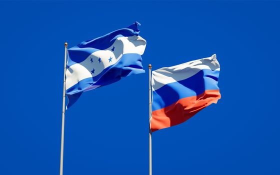 Beautiful national state flags of Honduras and Russia together at the sky background. 3D artwork concept. 