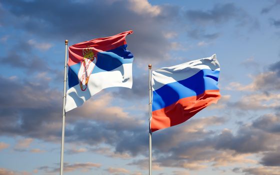 Beautiful national state flags of Serbia and Russia together at the sky background. 3D artwork concept. 