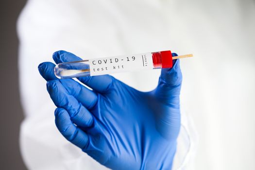 COVID-19 virus disease self swab test sample kit, medical laboratory scientist holding a test tube with throat swab viral specimen collection equipment, Coronavirus health check 