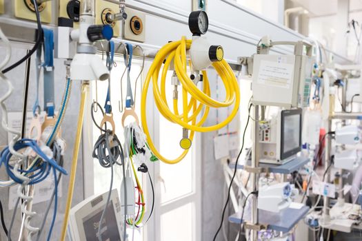 Medical equipment in UK NHS hospital emergency room, yellow pipe hose & healthcare devices on rack in background,surgery department,corona virus COVID-19 epidemic pandemic crisis high death toll rate