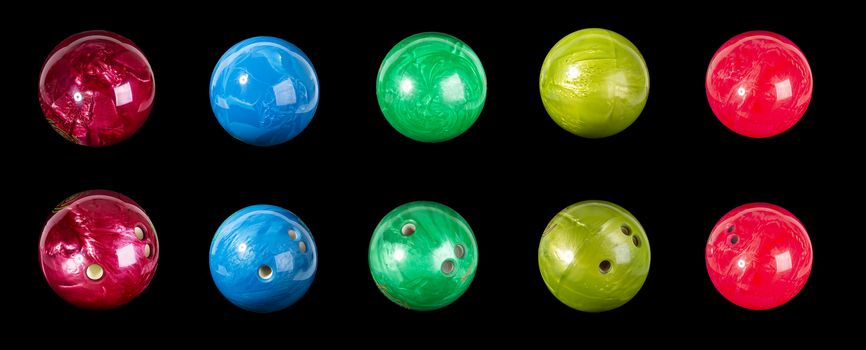 Set of colorful balls for bowling red blue light green. Isolated on a black background close-up.