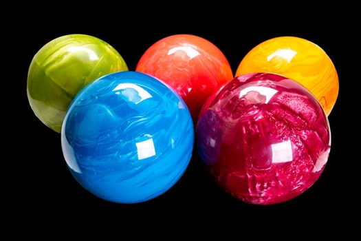 colorful bowling balls isolated on black background. blue red orange yellow green
