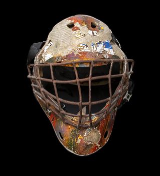 Old hockey mask for goalkeeper protection isolated on black background