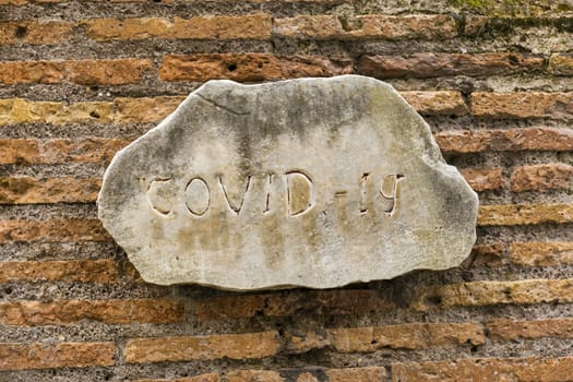 Antique sign with the inscription COVID-19. The concept of the spread of the virus in Italy.