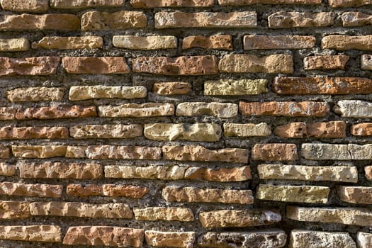 Old brickwork. Antique masonry. Weathered wall, a binding solution is visible. Background texture Pattern