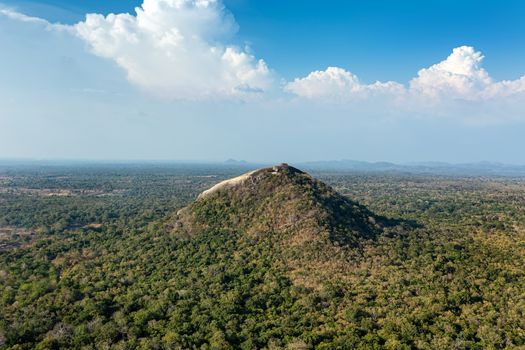 Pidurangala rock. View of Pidurangala from a height from the side of the Sigiriya rock. Geological formation landscape with a separate rock of volcanic origin of igneous rocks. aerial view
