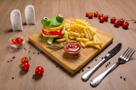 Crazy frog burger chicken fillet cutlet, toast cheese, dried burger bun, green, ketchup, fresh tomato, bell pepper, iceberg, olives, french fries ketchup