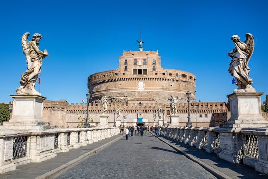 28.02.2020 in Rome, Italy. Frontal view of the Castel Sant'Angelo against the blue sky. Tourists walk nearby