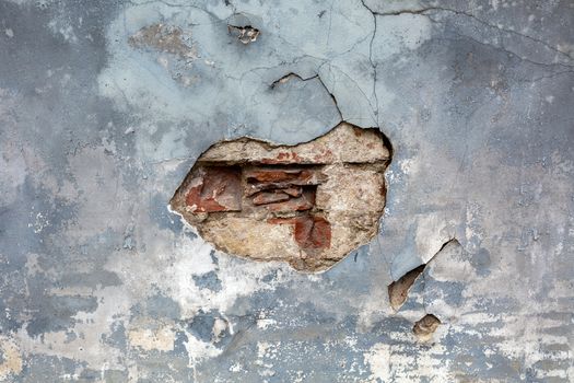 Natural destroyed stone surface. Vintage rustic pattern. Brown background. Old shabby cracked stucco. Dirty wall, grunge texture. Painted concrete