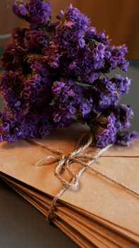 Envelopes with dry lavender. Stack of vintage letters tied with twine vertical photo