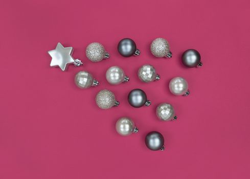 Comet from Christmas tree baubles on pink paper.