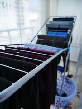 Drying clothes on the balcony in winter, drying clothes on the glass balcony, wet clothes are dried,