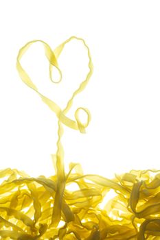 Swirls of cooked spaghetti with fork. Spaghetti heart shape