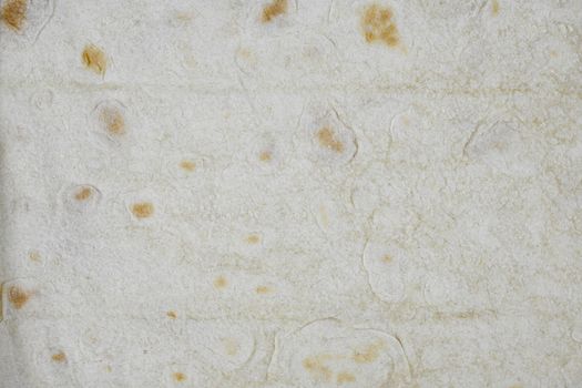 Texture of thin traditional freshly baked homemade oriental bread. Close-up Armenian pita bread - lavash as a textured bread background