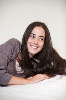 Portrait of a young and sweet natural woman without makeup with long brown hair