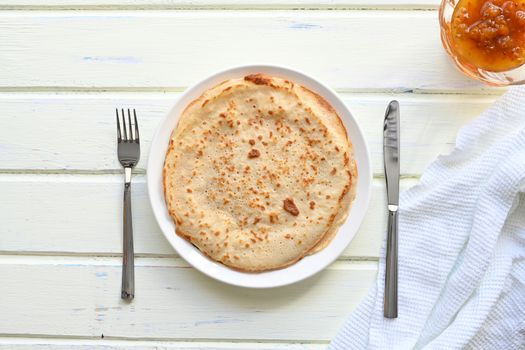 large pancakes with jam on white background