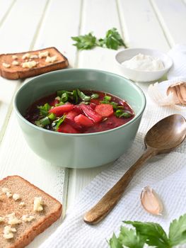 Traditional Ukrainian Russian vegetable soup, borsch with garlic donuts and bread.