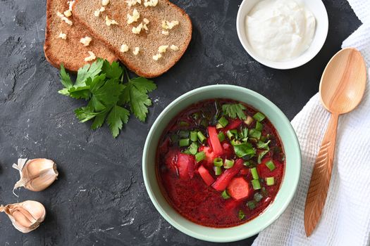 Traditional Ukrainian Russian vegetable soup, borsch with garlic donuts and bread.