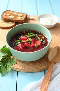Traditional Ukrainian Russian vegetable soup, borsch with garlic donuts and bread.