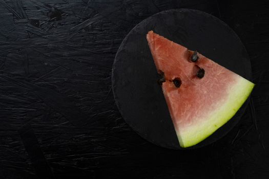 Watermelon on dark table. Sliced watermelon on the black background
