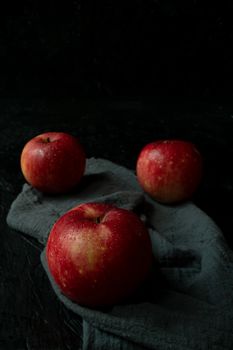 Red apple isolated on black wooden background