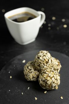 Homemade energy balls with hazelnut on dark background