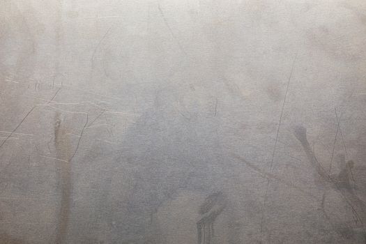 Uncoated flat cold rolled metal sheet surface with minor scratches. Close-up in directly above composition.