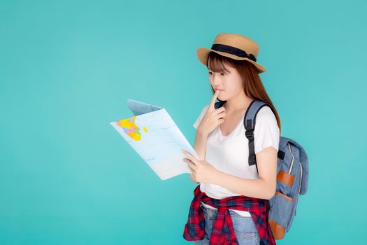 Beautiful portrait young asian woman travel holding and looking a paper map isolated on blue background, asia girl think and idea search journey with direction in vacation trip for leisure.