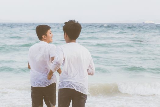 Homosexual portrait young asian couple running with cheerful together on beach in summer, asia gay going tourism for leisure and relax with happiness in vacation at sea, LGBT legal concept.