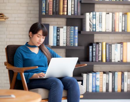 Business young asian woman freelance work on display laptop computer on chair, businesswoman check email, asia girl searching to internet communication and business concept.