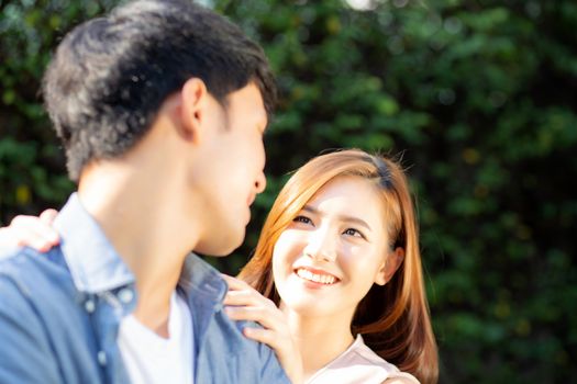 Beautiful portrait couple looking each others eyes and smiling with happy, young asian man and woman relation with love dating, husband and wife feeling and emotion, lovers and lifestyle concept.